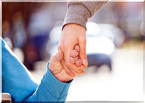 disabled person holding another person's hand