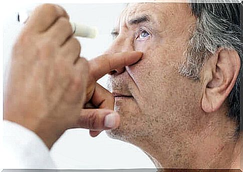 Examining a man's eyes after cataract surgery.