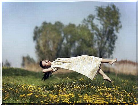 A girl levitating in a field