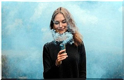 woman surrounded by blue smoke