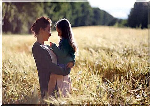 mother holding her daughter in her arms